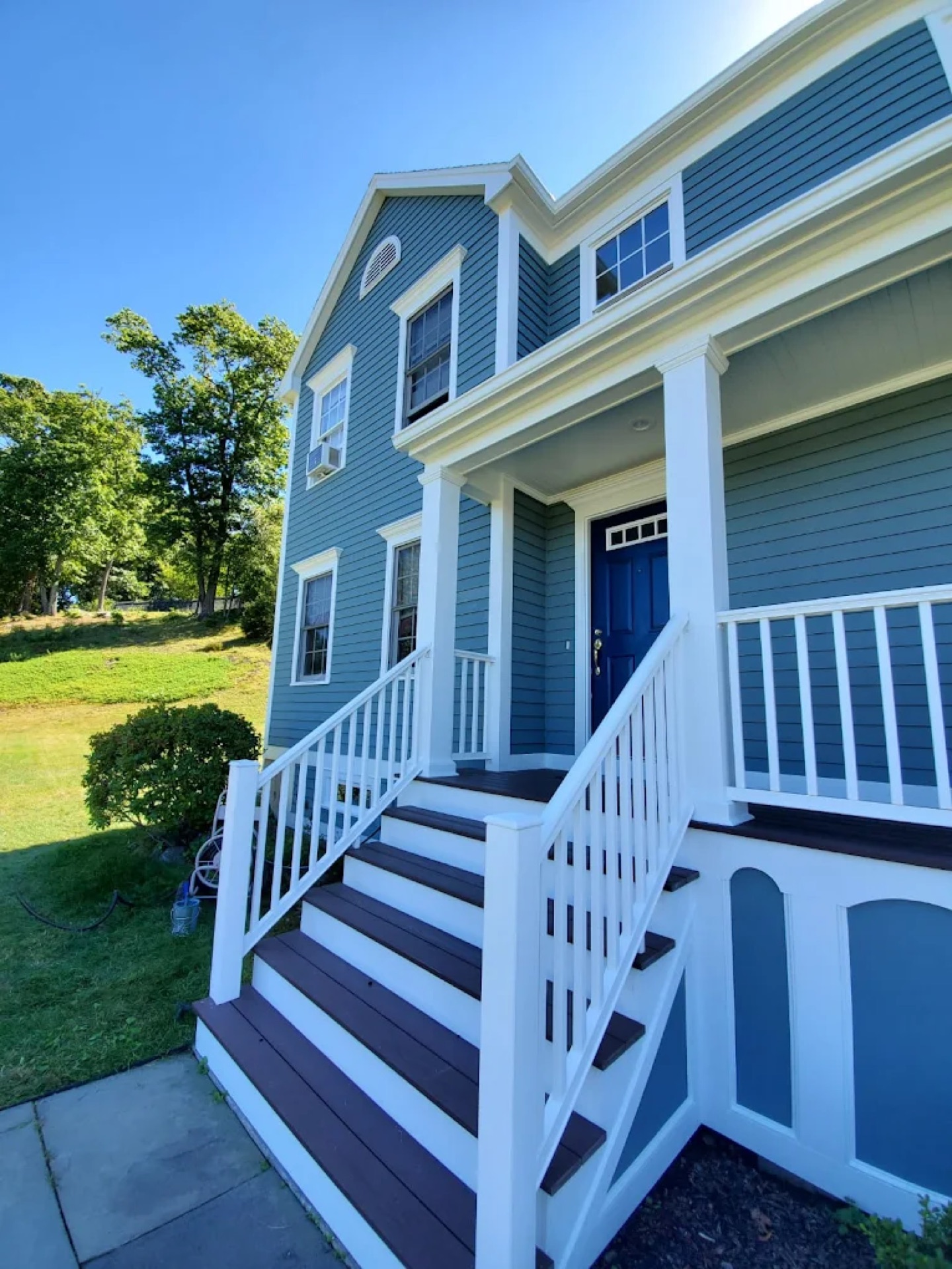 Exterior painting - blue colonial home with white stairs CT